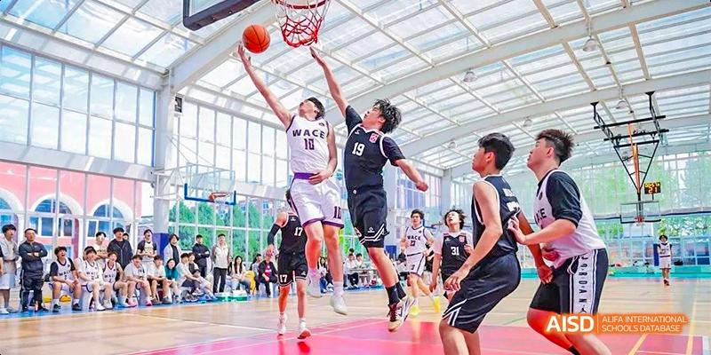 Beijing Aidi School students competing in a basketball game, with two players going for a rebound