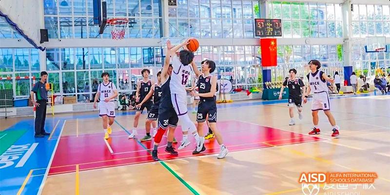 Beijing Aidi School basketball team playing on the court in black and white uniforms