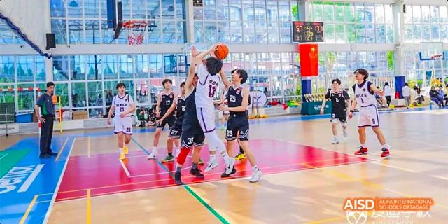 Beijing Aidi School basketball team playing on the court in black and white uniforms