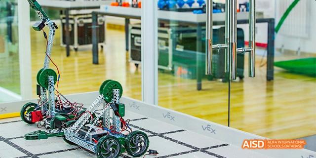 A robot on a competition field with the VEX Robotics logo, from a robotics event at Beijing Aidi School.