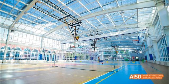 The indoor basketball and badminton court at Beijing Aidi School.