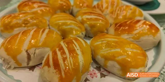 Golden-brown baked pastries with a flaky, glazed crust, likely from a baking lesson at Beijing No.8 High School.