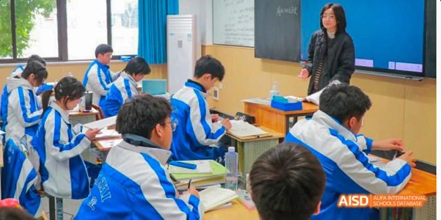 Chengdu Shishi High School Beihu Campus AP Curriculum students in a classroom, with one student raising their hand.