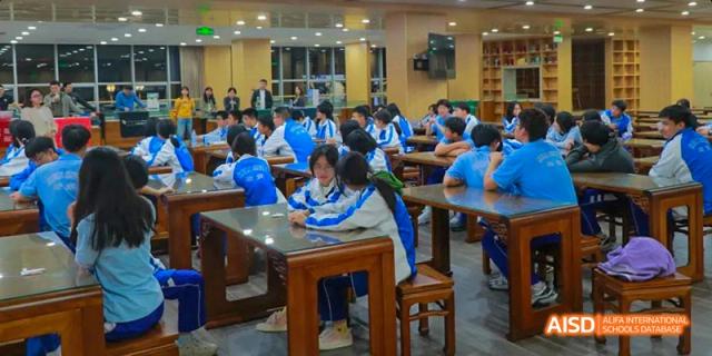 Chengdu Shishi High School Beihu Campus AP Curriculum students studying together at tables in a classroom.