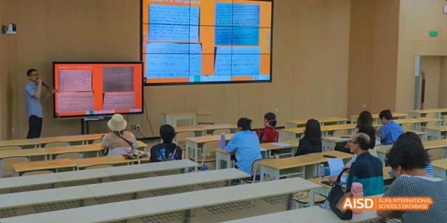 An empty classroom at Chengdu Shishi High School Beihu Campus AP Curriculum with a presentation visible on a screen.