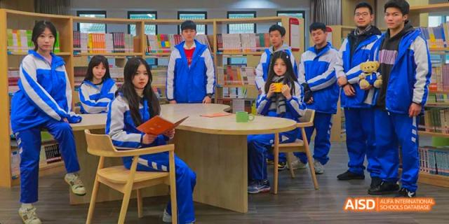 A group of Chengdu Shishi High School Beihu Campus AP Curriculum students pose for a photo around a table.