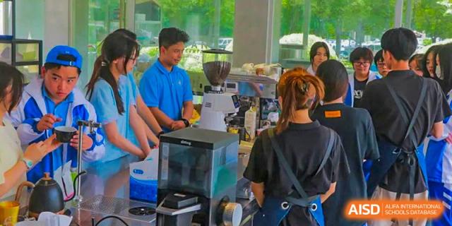 Chengdu Shishi High School Beihu Campus AP Curriculum student receiving training on making coffee in a cafe.