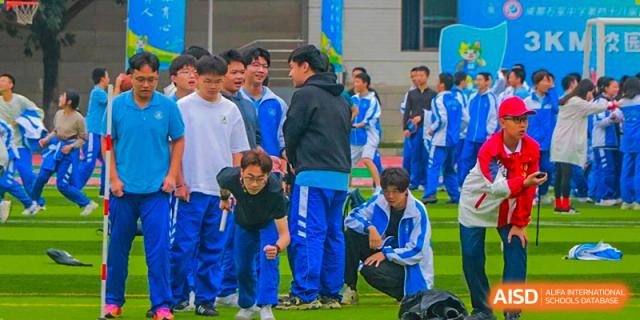 Chengdu Shishi High School Beihu Campus AP Curriculum students in blue and white uniforms huddle and prepare for a game.
