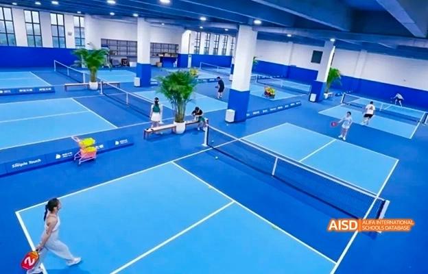 An indoor sports complex with a tennis court and other blue courts at Chongqing Depu Foreign Language School