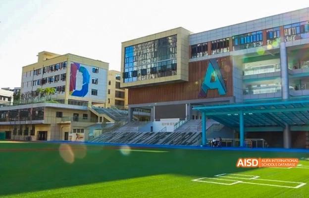 An outdoor view of the main building and a sports field at Chongqing Depu Foreign Language School