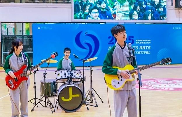 A student playing an electric guitar and another playing drums at Chongqing Depu Foreign Language School
