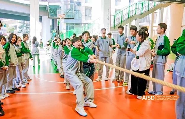 Students participating in a tug-of-war game at Chongqing Depu Foreign Language School