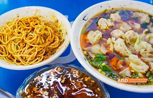A bowl of noodles and a bowl of dumplings at the cafeteria of Chongqing Depu Foreign Language School