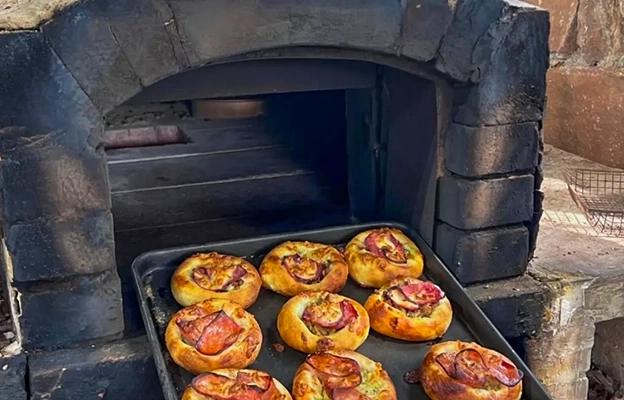 Freshly baked buns on a baking tray inside an oven at Chongqing Depu Foreign Language School