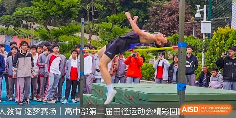 An athlete performing a high jump or back flip over a mat during a sports competition at DongGuan Laguna Verona Foreign Language School.