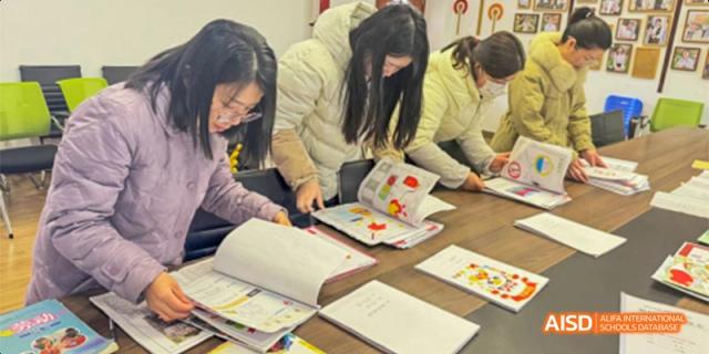 Guiyang Prime School students gathered around a table, collaborating or studying from open textbooks.