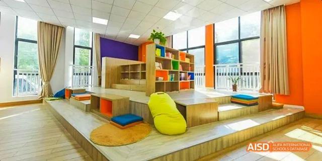 A comfortable and colorful reading nook or relaxation area with beanbag chairs and shelves at Hangzhou World Foreign Language School.