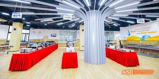 A stylish, modern hallway entrance at Hangzhou World Foreign Language School, featuring a unique, curved pillar.