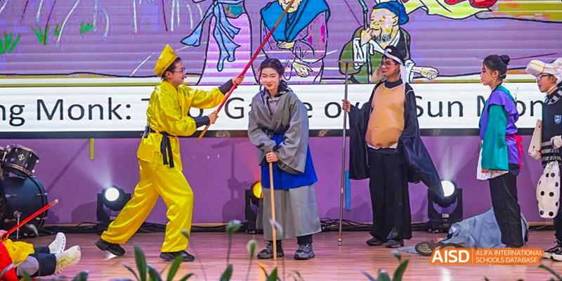 A person in traditional clothing is participating in a game at an event at Hangzhou World Foreign Language School.