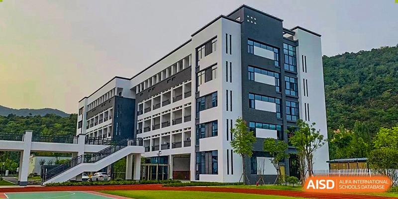 A modern, multi-story school building with large windows at Hangzhou World Foreign Language School.