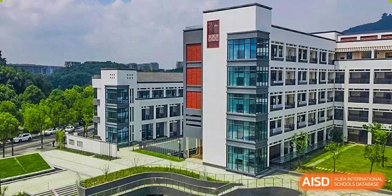 A modern, multi-story school building with red accents at Hangzhou World Foreign Language School.