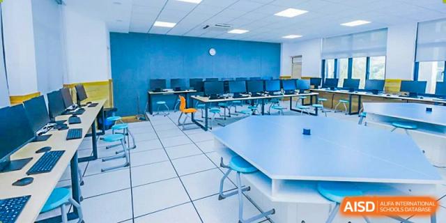 A computer lab with multiple computers and chairs at Hangzhou World Foreign Language School.