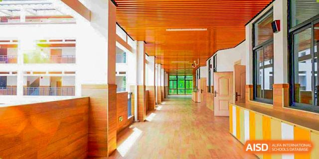 A bright, clean hallway with large windows and a wooden floor at Hangzhou World Foreign Language School.