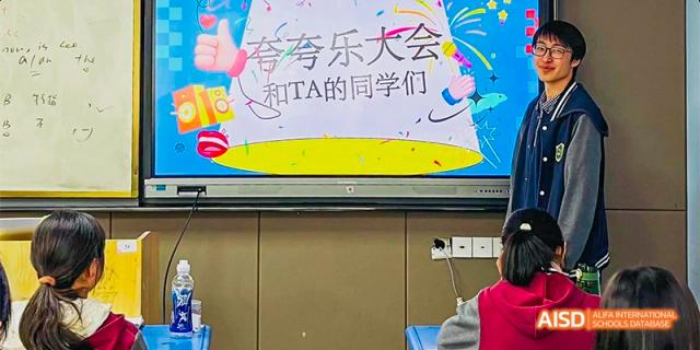 A colorful digital display showcases a student "praise assembly" event on a large smart screen inside a classroom at Hefei No.8 High School.