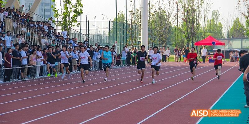 Students participating in a running race on an outdoor track at Hefei No.8 High School .