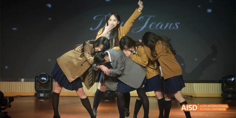 A group of students on a stage performing a dance or theatrical act at Hefei No.8 High School .