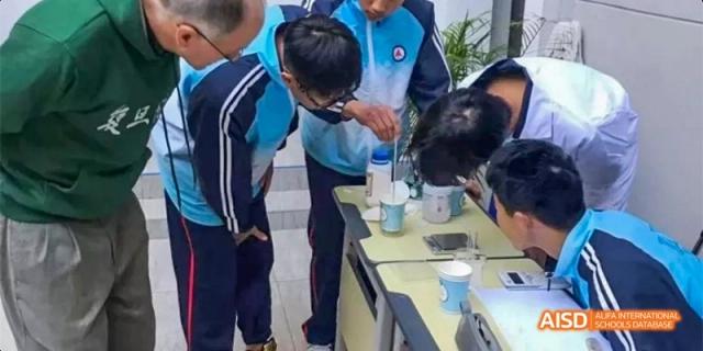 A teacher helps a student from Kunming No.1 High School International Education with a science experiment in a lab.