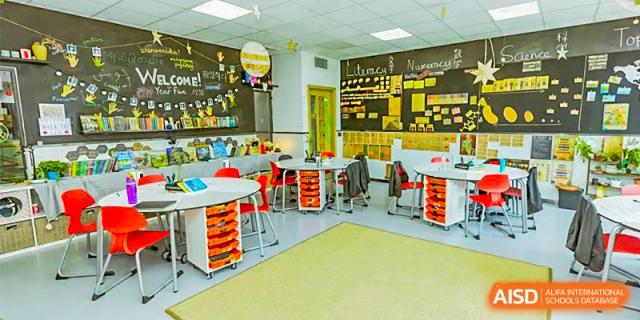 A modern, colorful classroom at Lady Eleanor Holles International School Foshan (LEH Foshan) with bright green and red chairs.