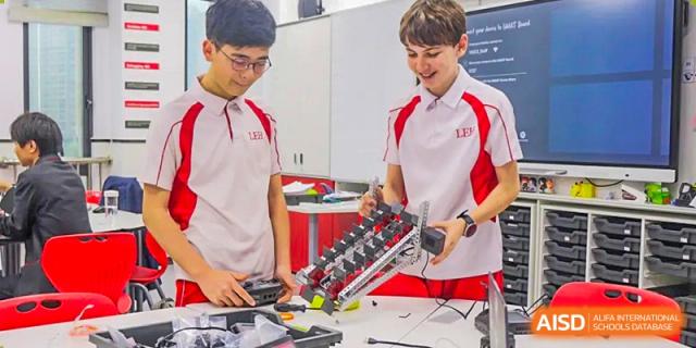 Two students from Lady Eleanor Holles International School Foshan (LEH Foshan) work together on a science or robotics project.