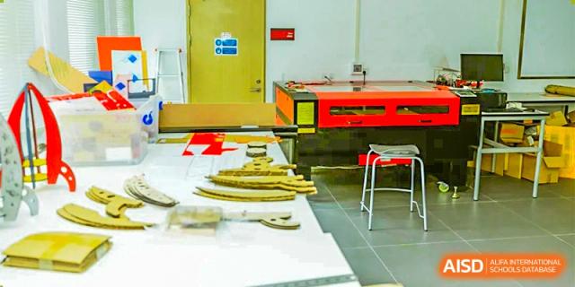 A science classroom at Lady Eleanor Holles International School Foshan (LEH Foshan) with a yellow workbench and various lab equipment.