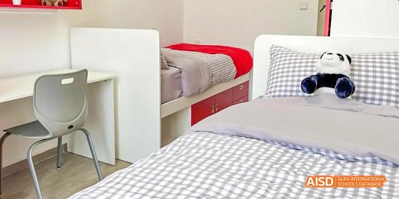 A clean and tidy student dorm room with a single bed at Lady Eleanor Holles International School Foshan(LEH Foshan).