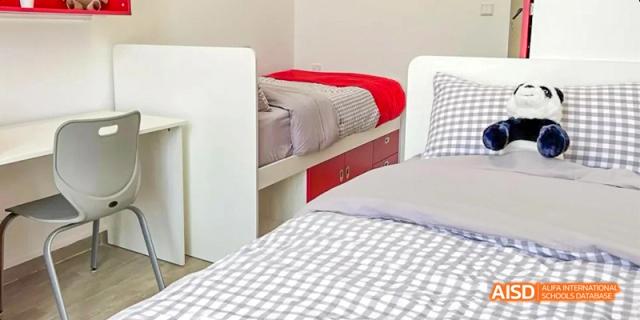 A clean and tidy student dorm room with a single bed at Lady Eleanor Holles International School Foshan(LEH Foshan).