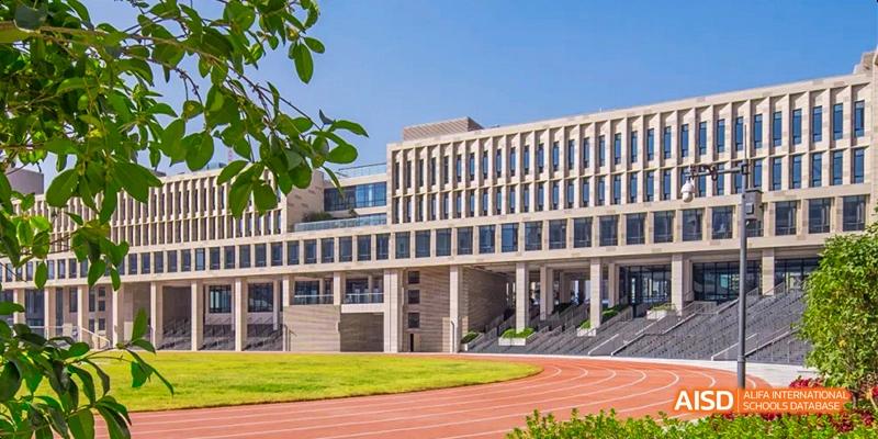 The main building of Lady Eleanor Holles International School Foshan(LEH Foshan) seen from the sports field on a sunny day.