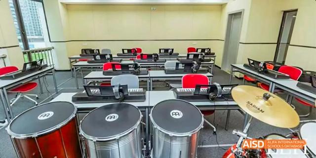 A music room at Lady Eleanor Holles International School Foshan(LEH Foshan) with a row of drums and other percussion instruments.