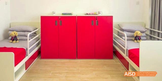 A kitchen or pantry area at Lady Eleanor Holles International School Foshan (LEH Foshan) with bright red cabinets.