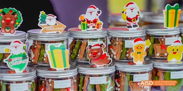 Decorated holiday cookies with Santa and reindeer designs in festive boxes at a Lady Eleanor Holles International School Foshan (LEH Foshan) event.
