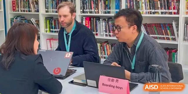 Teachers from Nord Anglia School Guangzhou Panyu helping students with a project in the school library.