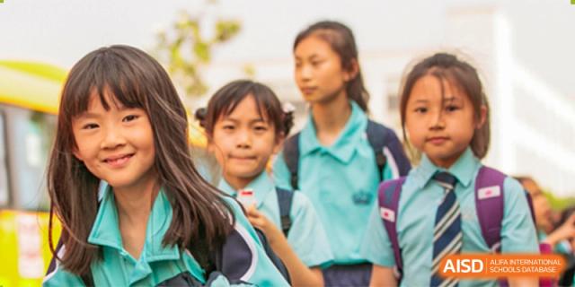 A group of young students from Nord Anglia School Guangzhou Panyu smiling while wearing their school uniforms.