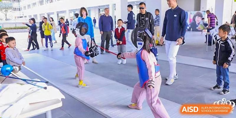 A student from Nord Anglia School Guangzhou Panyu in fencing gear during a sports competition.