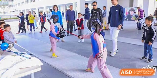 A student from Nord Anglia School Guangzhou Panyu in fencing gear during a sports competition.