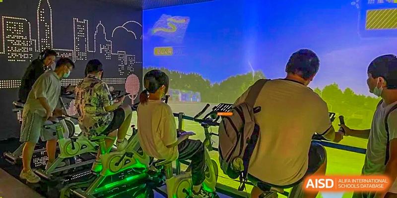 A student exercising indoors on a stationary bike or elliptical machine at Orange County American High School Beijing Campus.