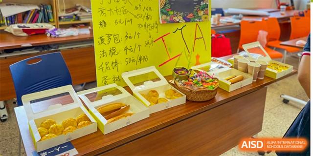Boxes of pastries and baked goods set out on a table for a student event or snack time at Orange County American High School Beijing Campus.