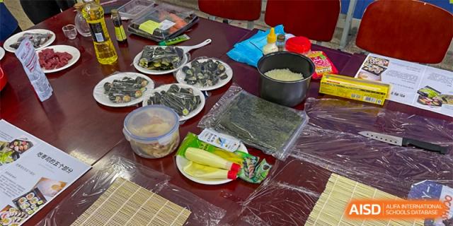 Ingredients including seaweed, rice, and vegetables laid out on a table for a cooking or cultural food preparation activity at Orange County American High School Beijing Campus.