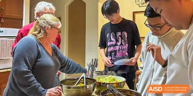 Students serving themselves from a variety of fresh salads and prepared dishes in a serving line at Orange County American High School Beijing Campus.