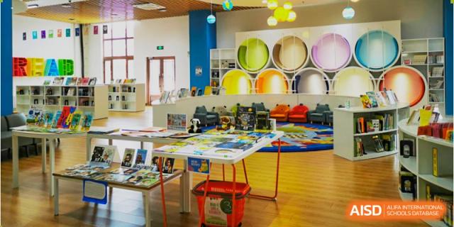 A vibrant early learning or creative classroom at Oriental Cambridge International School, decorated with large colorful circles and mirrors on the wall.