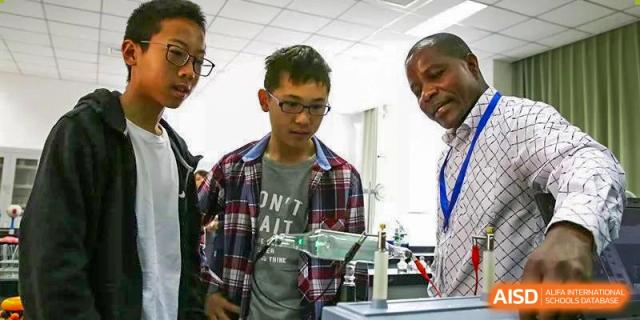 A teacher from RCF Experimental School helping a student with a project.